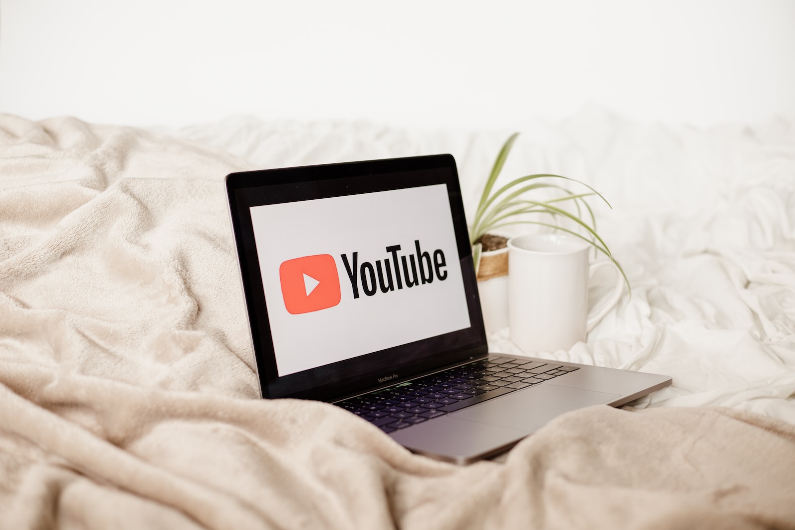 a laptop computer sitting on top of a bed